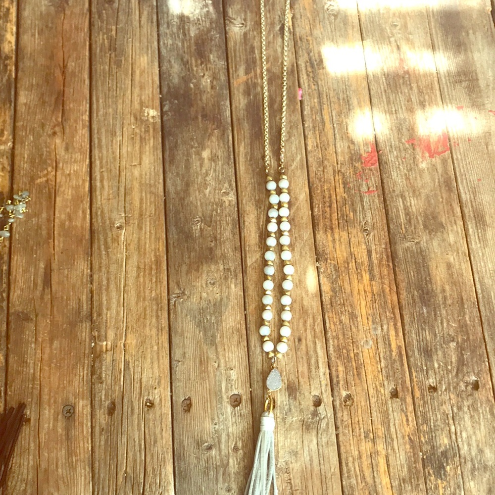 Long necklace with leather tassels and gem